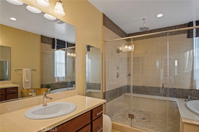 bathroom with walk in shower and vanity