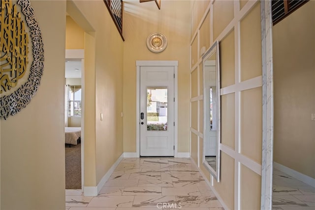 foyer featuring a towering ceiling