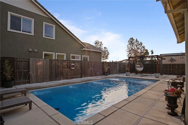 view of pool with pool water feature and a pergola