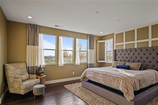 bedroom with dark hardwood / wood-style floors