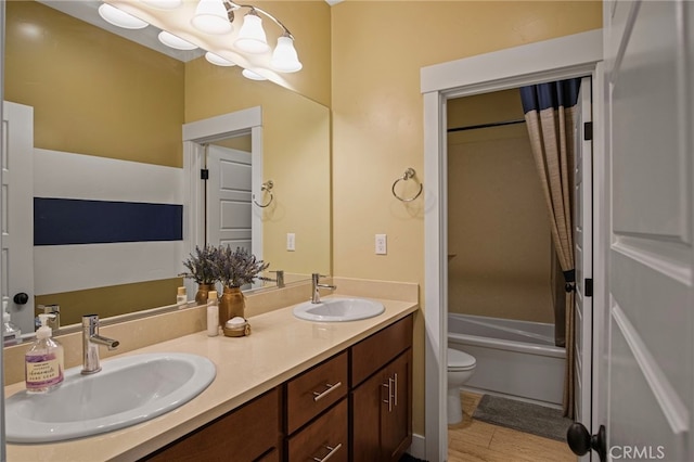 full bathroom featuring shower / bath combo with shower curtain, toilet, and vanity