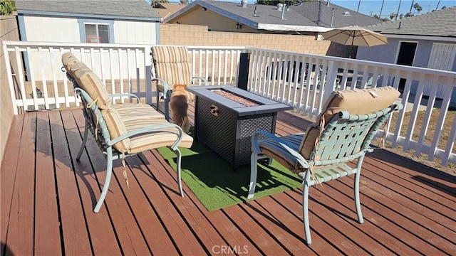 wooden deck featuring a fire pit