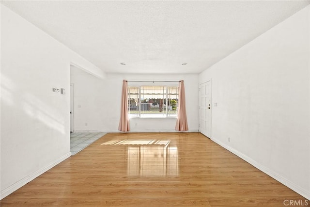 empty room with light hardwood / wood-style flooring