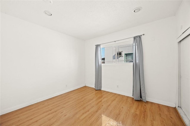 empty room with light hardwood / wood-style flooring