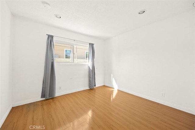 spare room with hardwood / wood-style floors