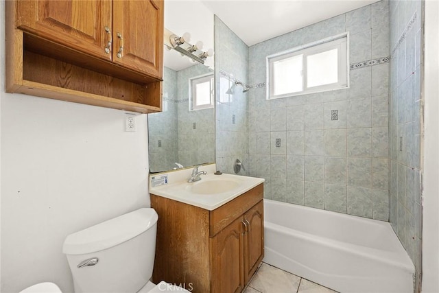 full bathroom featuring toilet, tile patterned flooring, tiled shower / bath combo, and vanity