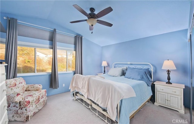 bedroom featuring ceiling fan, lofted ceiling, and light carpet