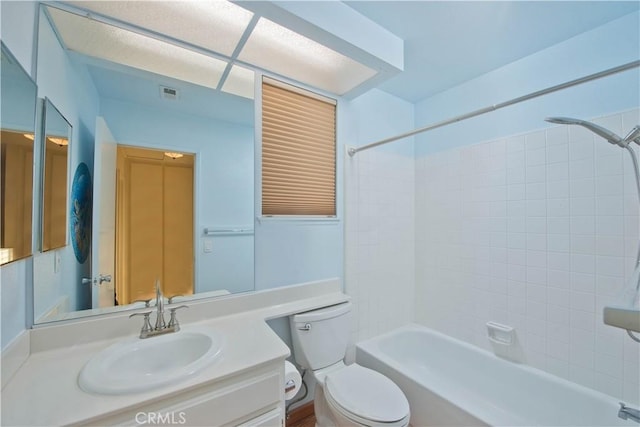 full bathroom featuring vanity, toilet, and tiled shower / bath