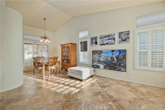 interior space featuring high vaulted ceiling and a notable chandelier