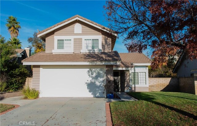 front of property featuring a garage and a front lawn