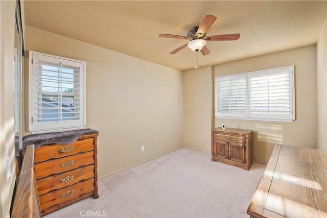 bedroom featuring ceiling fan and light carpet