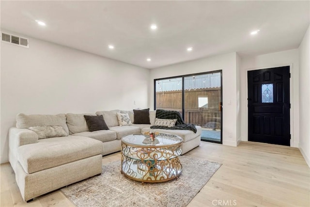 living room featuring visible vents, recessed lighting, light wood-style flooring, and baseboards