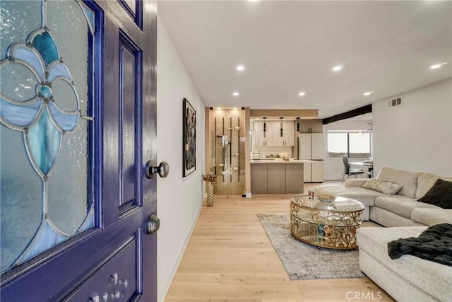 living area with baseboards, recessed lighting, light wood-style flooring, and visible vents