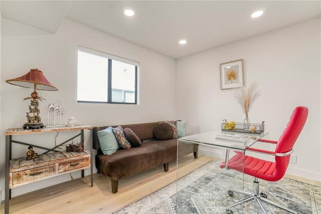 interior space with baseboards, recessed lighting, and wood finished floors