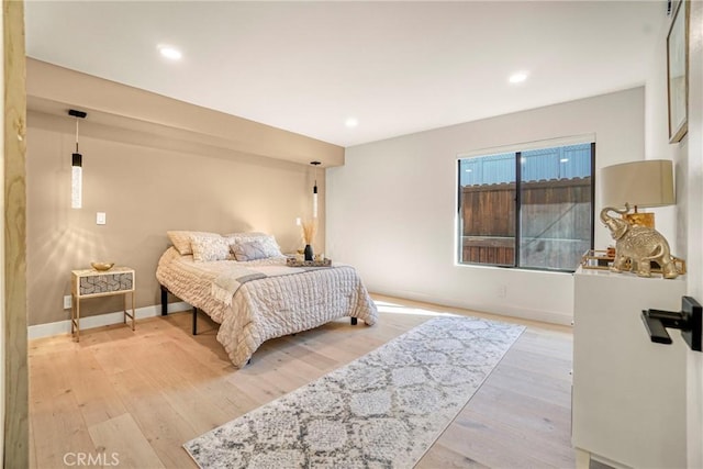 bedroom with recessed lighting, baseboards, and light wood-style floors