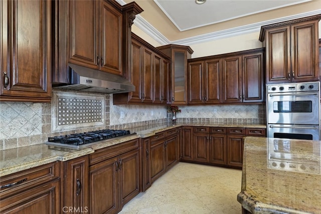 kitchen with backsplash, crown molding, light stone countertops, appliances with stainless steel finishes, and dark brown cabinets