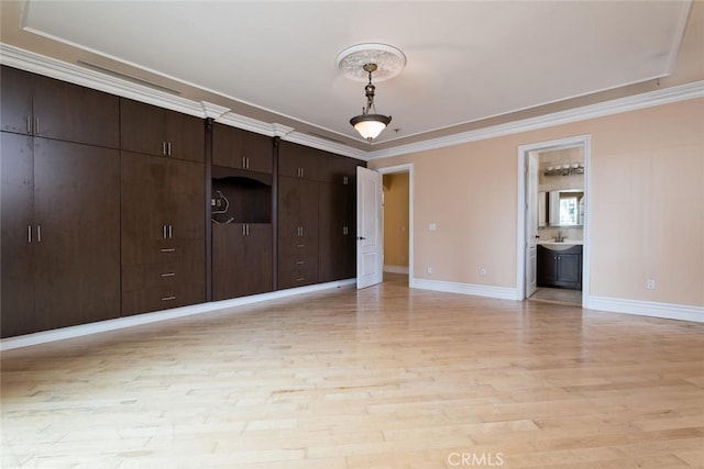 interior space featuring sink, light hardwood / wood-style flooring, and crown molding