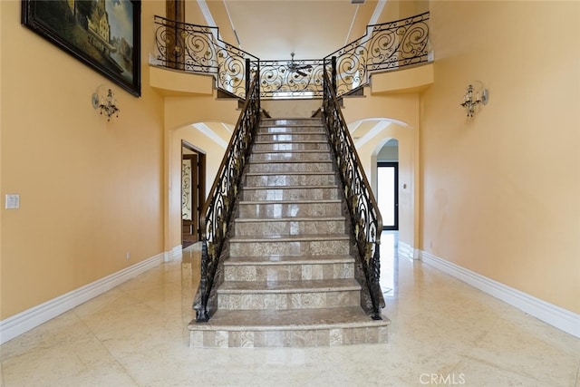 staircase featuring a high ceiling