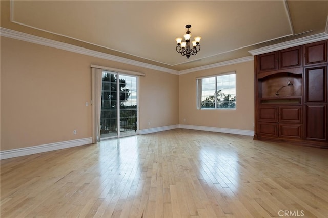 unfurnished dining area featuring an inviting chandelier, ornamental molding, and light hardwood / wood-style floors