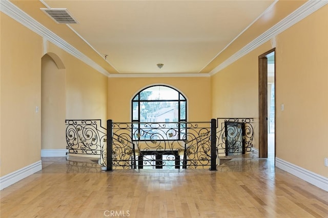 unfurnished living room featuring ornamental molding and hardwood / wood-style floors