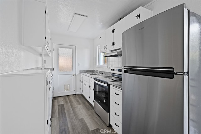 kitchen with sink, light wood-type flooring, appliances with stainless steel finishes, a textured ceiling, and white cabinets