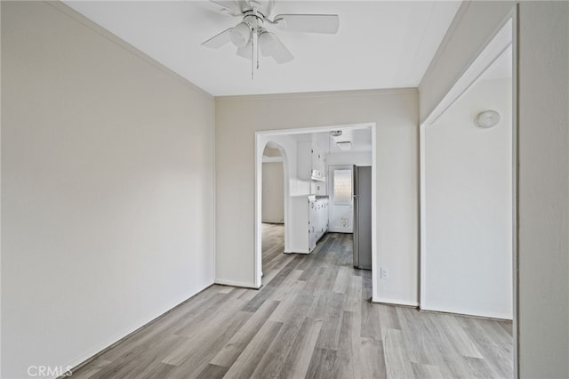 corridor featuring light wood-type flooring and ornamental molding