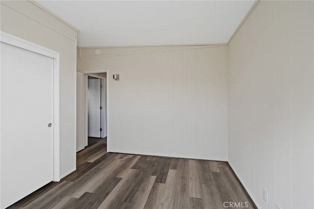 empty room featuring dark hardwood / wood-style floors and lofted ceiling