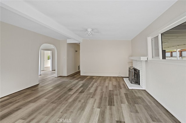 unfurnished living room with ceiling fan and wood-type flooring