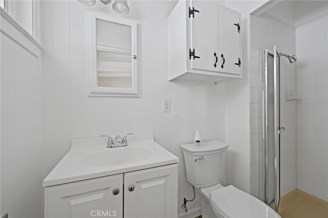 bathroom with walk in shower, vanity, and toilet