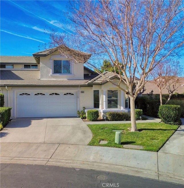 view of property with a front yard and a garage