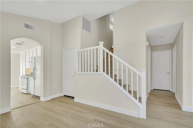 stairway with hardwood / wood-style floors