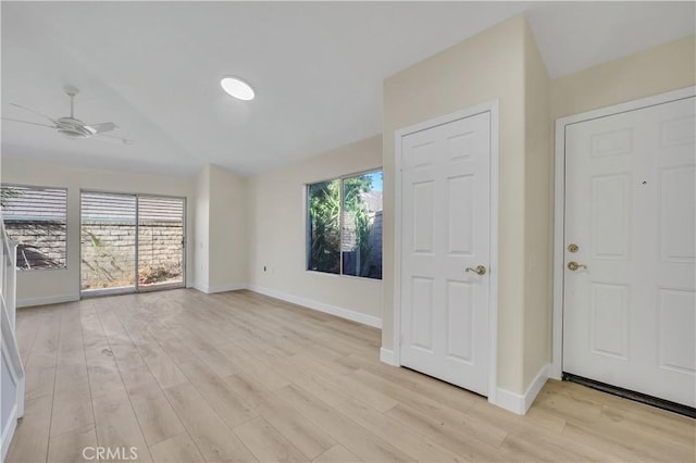 foyer with vaulted ceiling, ceiling fan, a healthy amount of sunlight, and light hardwood / wood-style floors