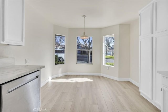 unfurnished dining area with light hardwood / wood-style floors