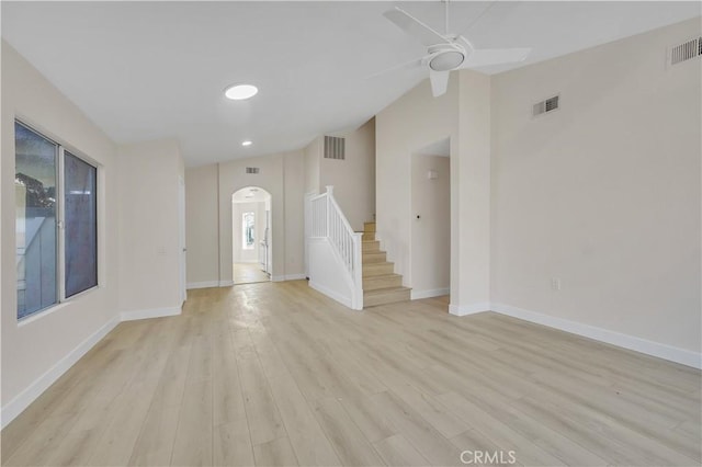 entryway with light wood-type flooring, ceiling fan, and vaulted ceiling