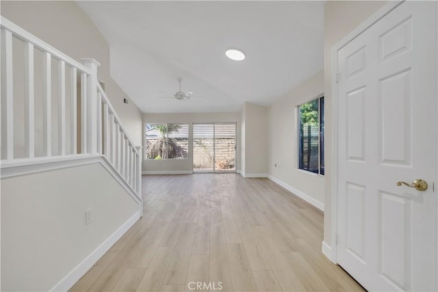 unfurnished living room featuring ceiling fan, light hardwood / wood-style floors, and plenty of natural light