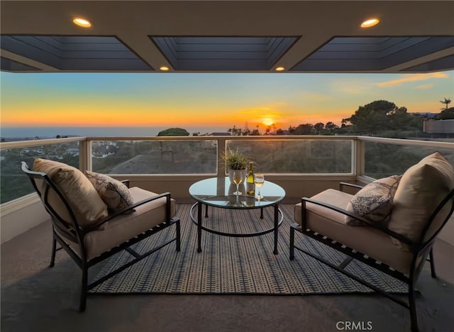 balcony at dusk with an outdoor living space