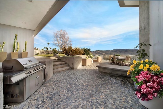 view of patio / terrace with a mountain view and area for grilling