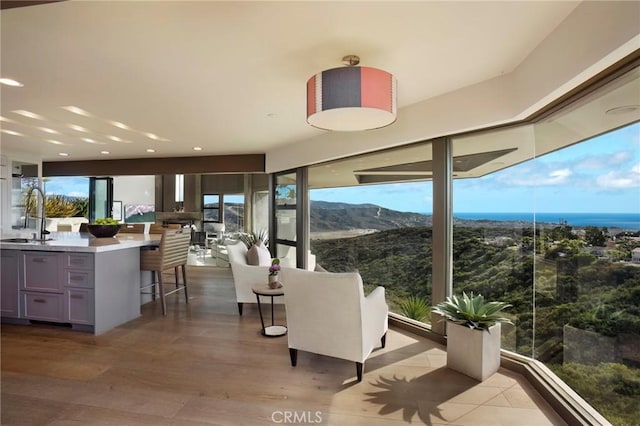 sunroom with sink and a mountain view