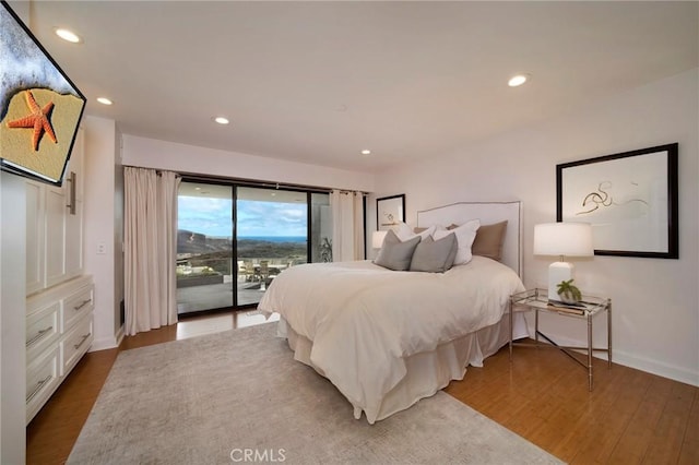 bedroom with hardwood / wood-style flooring and access to exterior