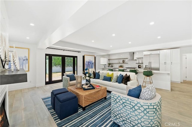 living room featuring french doors and light hardwood / wood-style floors