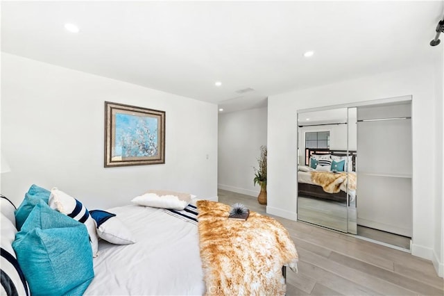 bedroom featuring a closet and light wood-type flooring