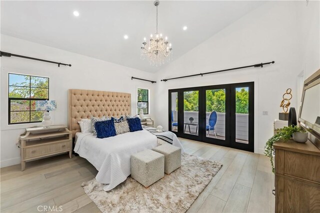 bedroom with access to exterior, light hardwood / wood-style floors, high vaulted ceiling, and a chandelier