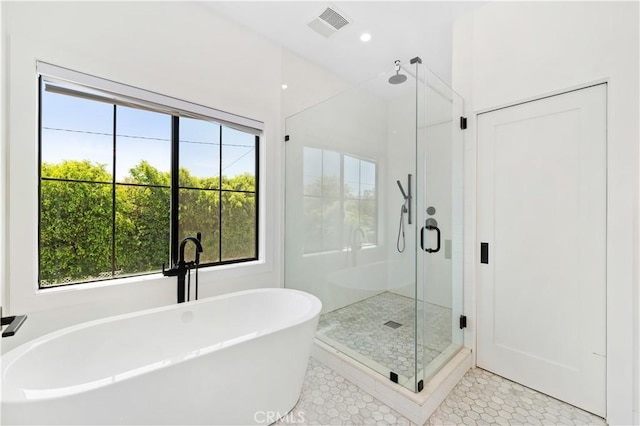 bathroom featuring tile patterned flooring, a healthy amount of sunlight, and separate shower and tub