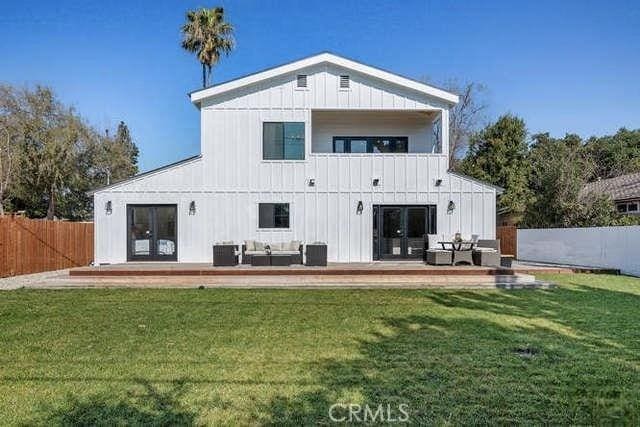 rear view of property featuring an outdoor living space, a lawn, and central air condition unit