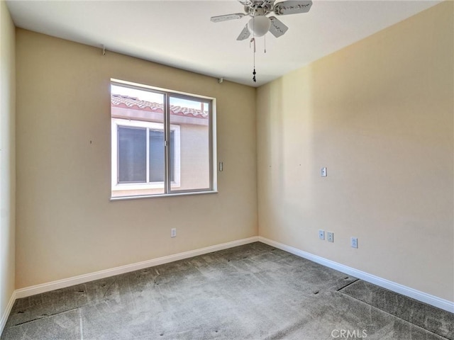 spare room featuring carpet and ceiling fan