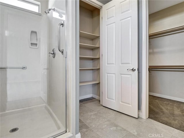 bathroom with a shower with door