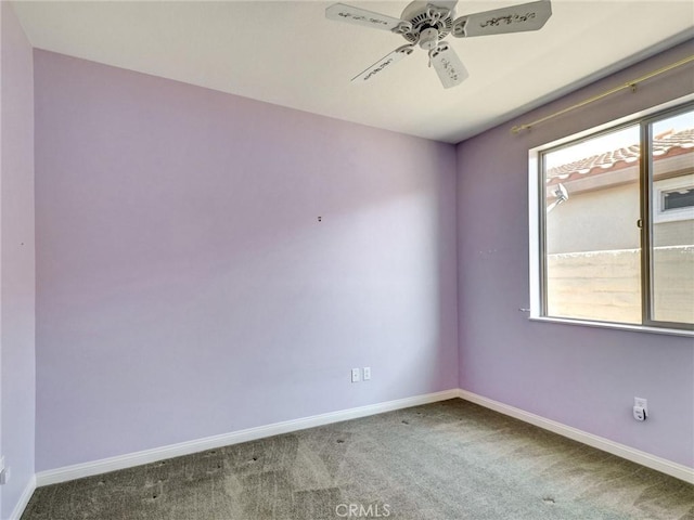 carpeted empty room with ceiling fan and a healthy amount of sunlight