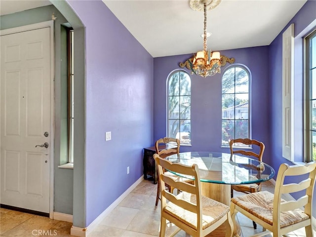 dining space with light tile patterned floors and a chandelier