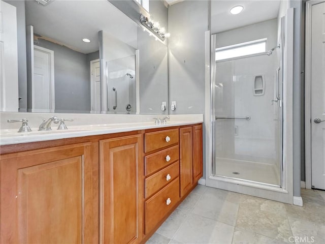 bathroom featuring a shower with shower door and vanity