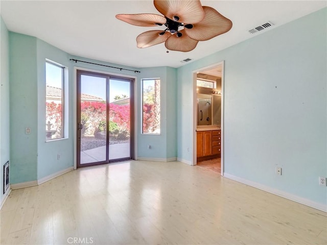 empty room with ceiling fan and light wood-type flooring